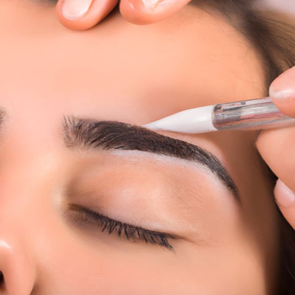 rofessional applying powder brows for a client using advanced techniques in Boca Raton.