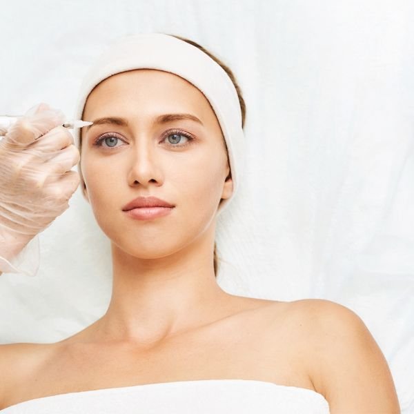 A professional mapping a client’s eyebrows before microblading at Beauty Power by Irina in Boca Raton.