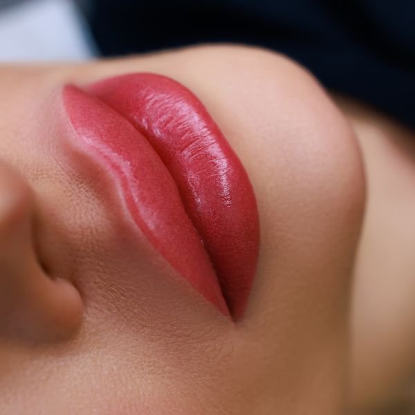 Close-up of tinted lips after a semi-permanent lip blushing procedure.