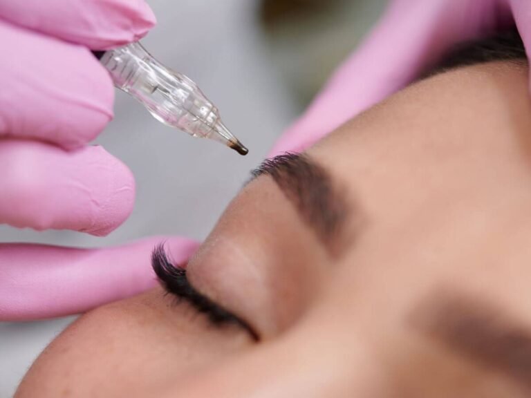 A close-up of a brow touch-up session to refresh the color and definition of previous permanent makeup.