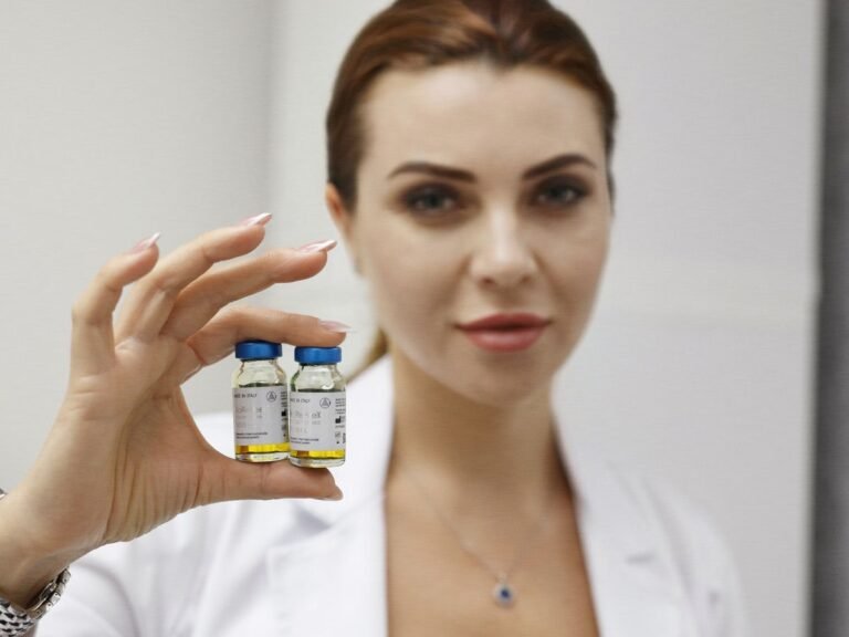 A skincare expert showcasing BioRePeel vials for advanced skin transformation treatments at Beauty Power by Irina in Boca Raton, Florida.
