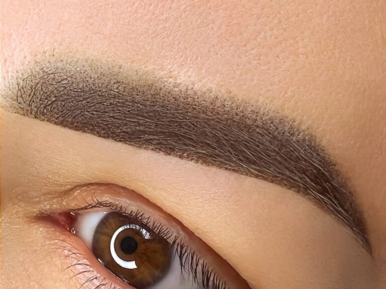 Soft, shaded powder eyebrows with a smooth gradient effect done using semi-permanent makeup techniques.