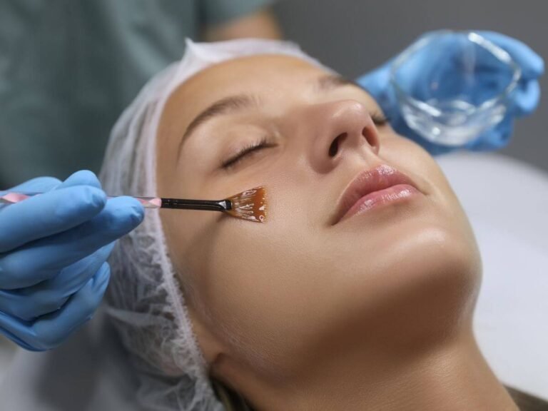 Professional applying a medical-grade chemical peel to exfoliate and rejuvenate the skin.