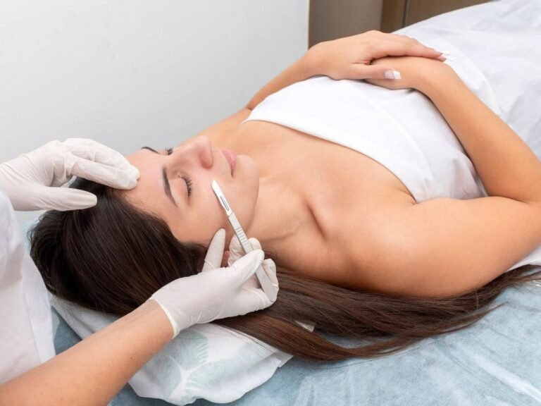 Certified beauty professional performing dermaplaning to gently exfoliate and remove peach fuzz.